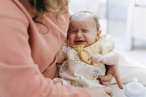 baby squirms and cries while bottle feeding|newborn squirming bottle.